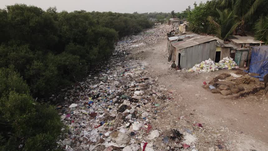Drone view of a third world country with garbage strewn across the whole land
