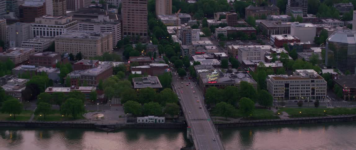 Heavy traffic passes down a highway through downtown