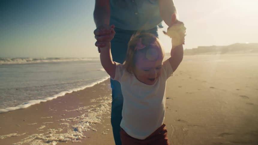 Family is walking on the beach in the middle of the day time