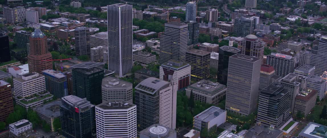 An aerial view of a city center dominated by a tower block