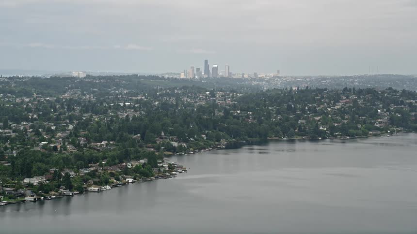 Aerial footage of Seattles skyline captured from lakefront homes in Rainier Beach Washington on an overcast day