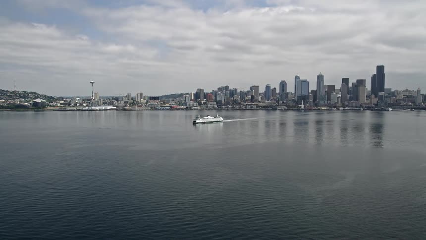 A ferry sails across Elliott Bay with the Seattle skyline in the background