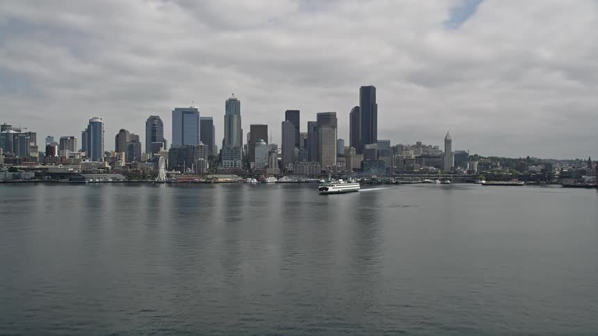 Aerial footage of Seattles Downtown skyline and ferry approaching from Elliott Bay
