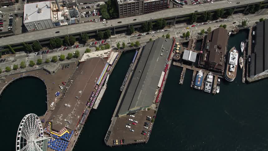 Aerial footage captures the Great Wheel Pier 56 and the Alaskan Way Viaduct in Downtown Seattle from a birds eye view