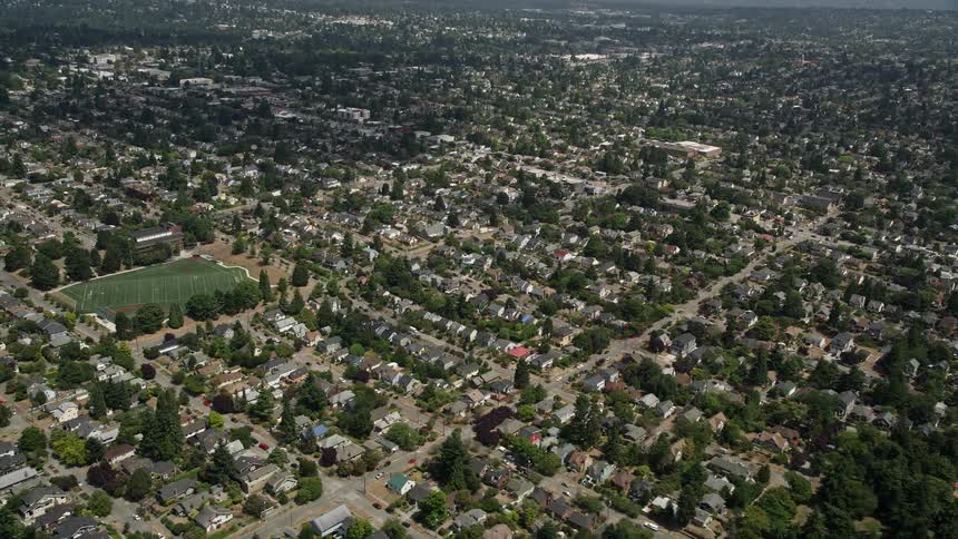 An aerial view of suburban neighborhoods in the Ballard area of Seattle Washington with sunny weather and residential houses visible