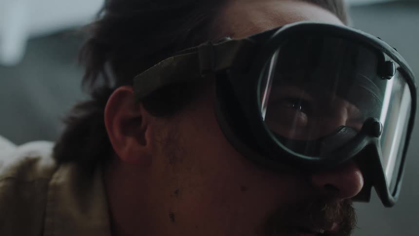 A man wears goggles to protect his eyes from strong wind