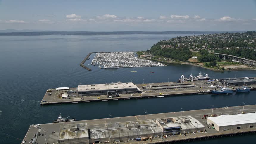 Approaching warehouse buildings on Pier 90 and 91 near the marina in Seattle Washington on a sunny day