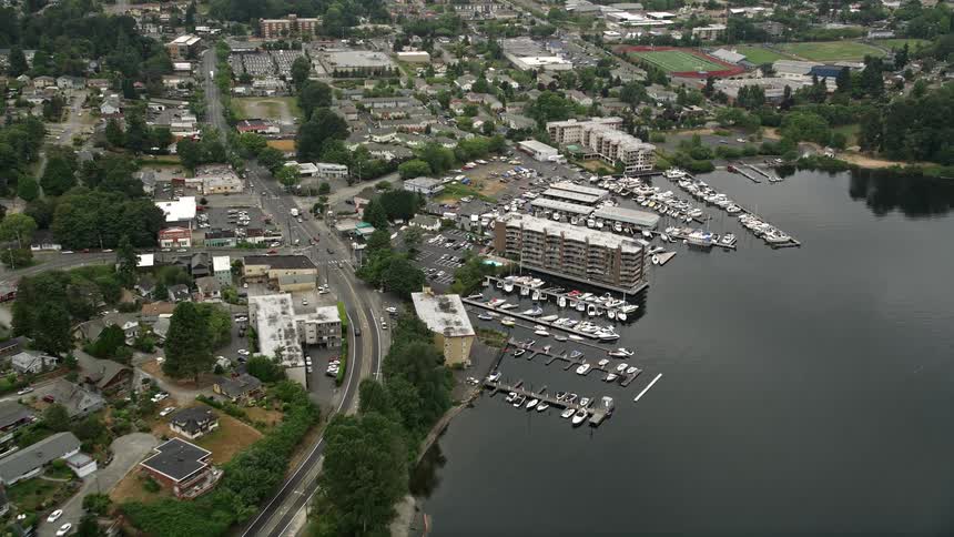 Approaching a small lakeshore marina and waterfront condo complexes in Rainier Beach Washington via aerial view