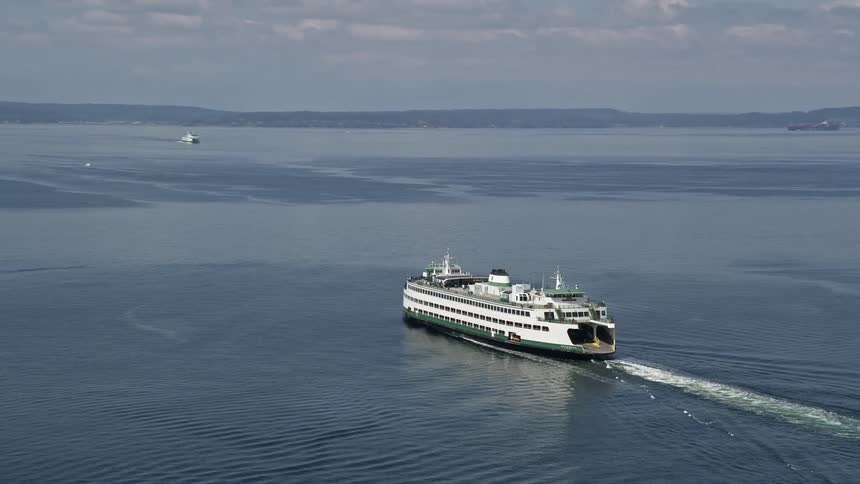 Aerial footage tracking a ferry sailing Elliot Bay Seattle on a sunny day