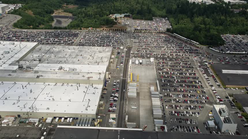Cars filling up factory parking lots as viewed from an aerial 5k footage of the Boeing Everett Factory in Paine Field Washington
