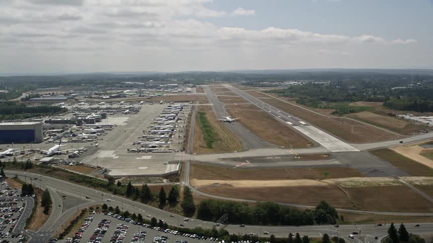 Aerial view of a 747 airliner on the runway at Paine Field Washington in partly cloudy skies