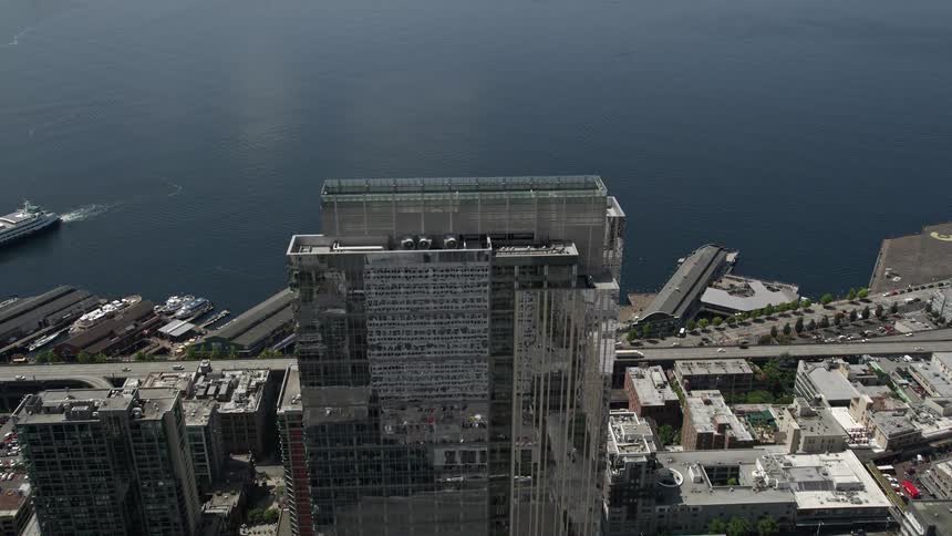 Aerial footage of Seattles downtown area showing the Russell Investments Center and tilting down to the Seattle Great Wheel on the Central Waterfront