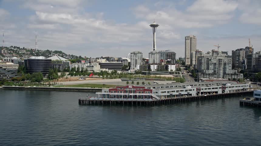 Aerial view of Seattles waterfront piers and office buildings with the Space Needle standing tall in the background