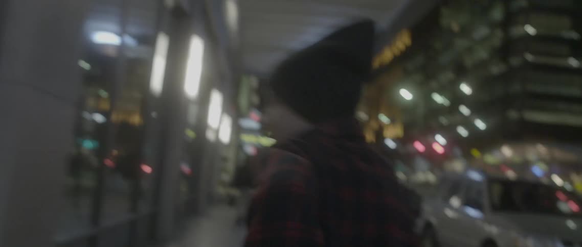 A person is running in the city at night