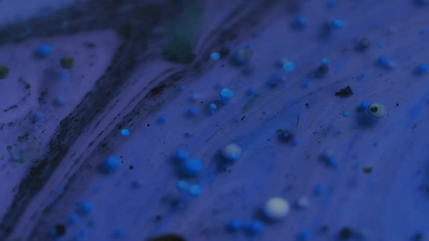 Close up of purple paint flowing