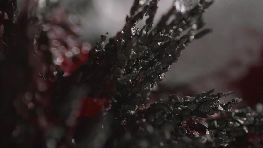 View of black crystalline spiked material