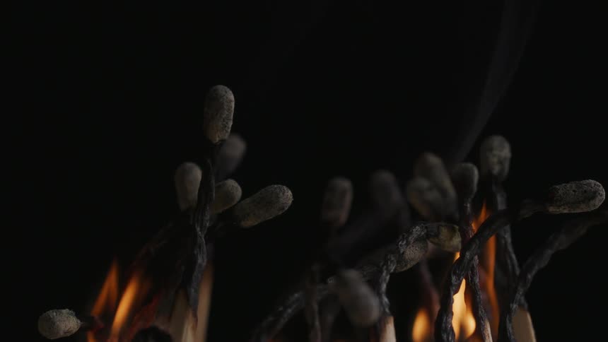 The last flames die off on burnt matches