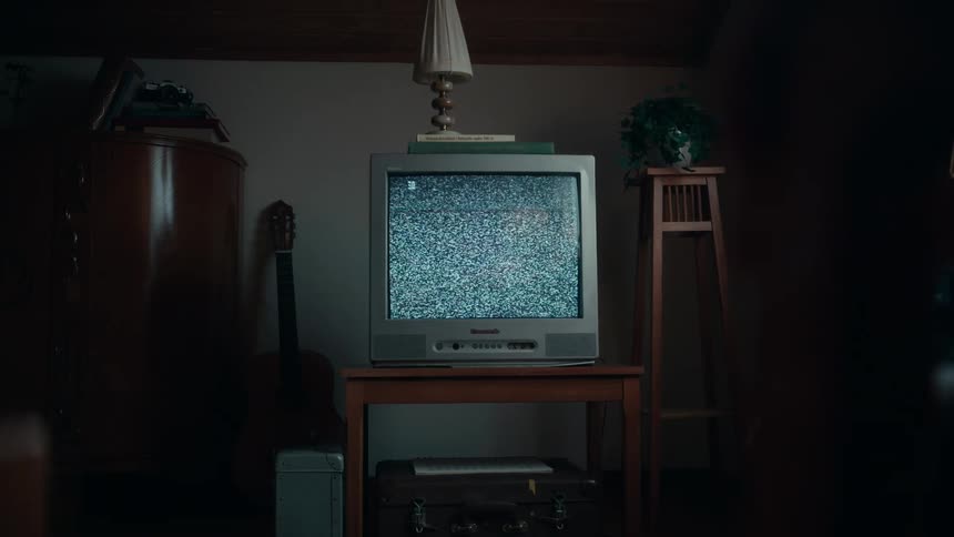 The view is of the indoors and you can see a television