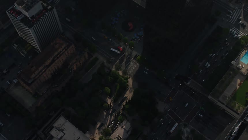 An aerial video clip featuring a birds eye view of the city streets and skyscrapers of Downtown Los Angeles California beginning with a view of US Bank Tower and tilting down to reveal the surrounding city