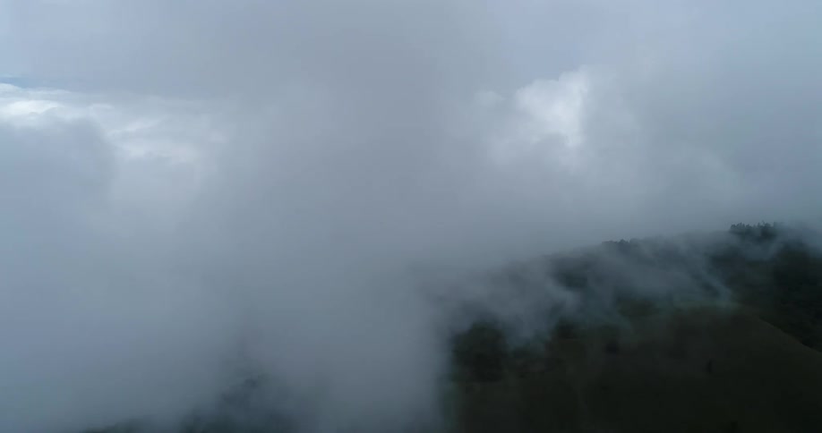 Low lying clouds obscure large portion of land