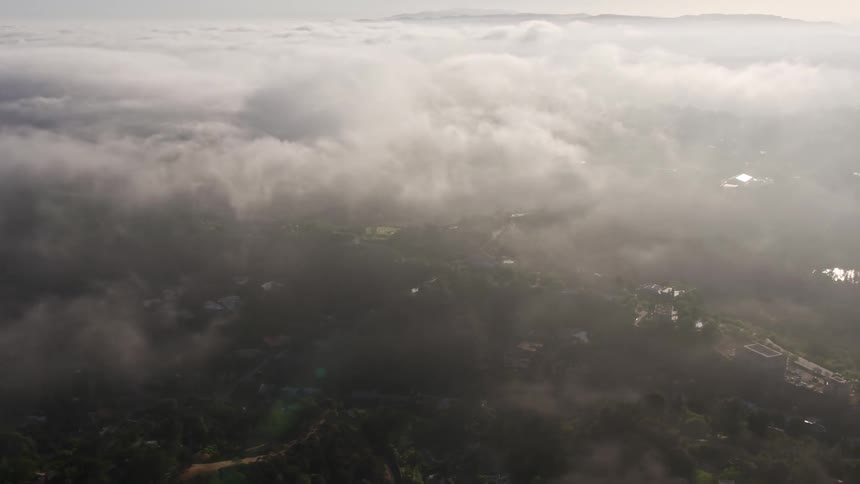 Aerial footage of a hazy marine layer rolling over Beverly Hills California