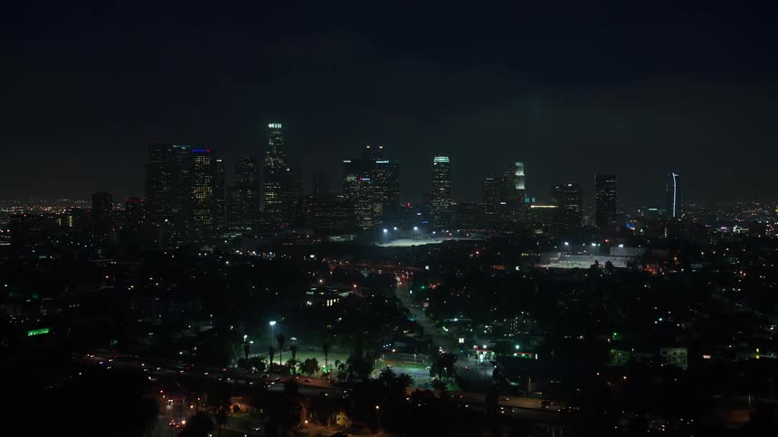Approaching the dazzling Downtown Los Angeles skyline on a cloudy night