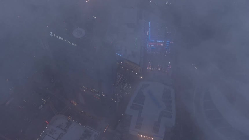 An aerial 4K stock footage of Staples Center and Nokia Theater in Downtown Los Angeles during dusk captured through a marine layer