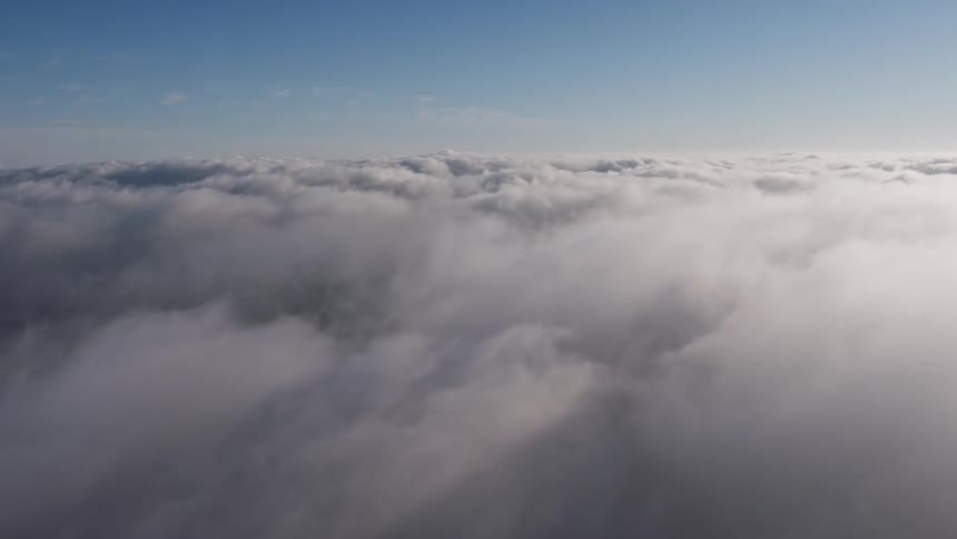 Aerial footage of Los Angeles California with a thick marine layer covering the city during the day