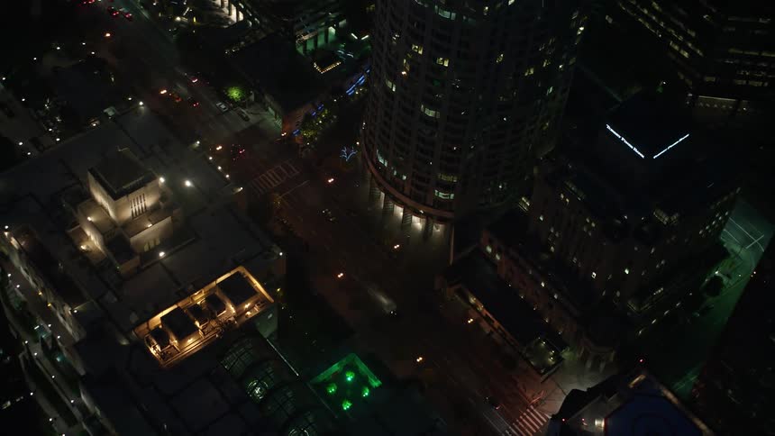 A breathtaking 4K aerial view of Downtown Los Angeles night scene with stunning city streets and skyscrapers illuminated by vehicle headlights