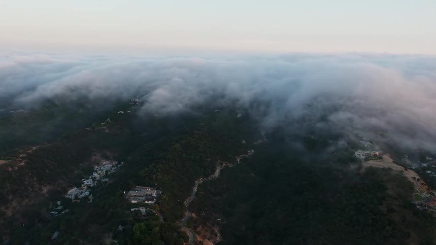Aerial footage captures stunning sunset over the foggy hills of Sherman Oaks California