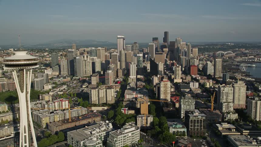 Aerial view of Downtown Seattle skyscrapers and high-rises revealing the iconic Space Needle and city landscape during the day in Washington