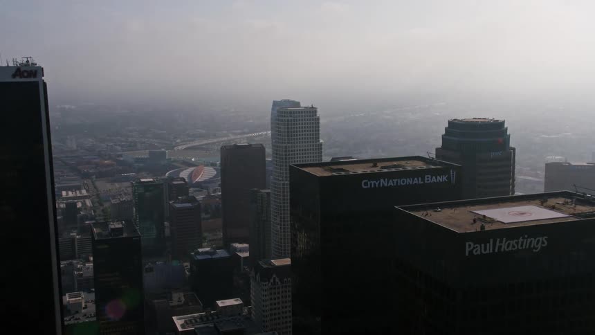 Flying over US Bank Tower City National Plaza and Paul Hastings Tower on a foggy day in Downtown LA