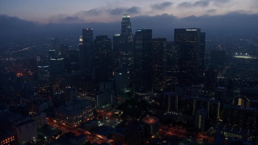 Approaching Downtown LAs skyline during twilight with a view of the marine layer
