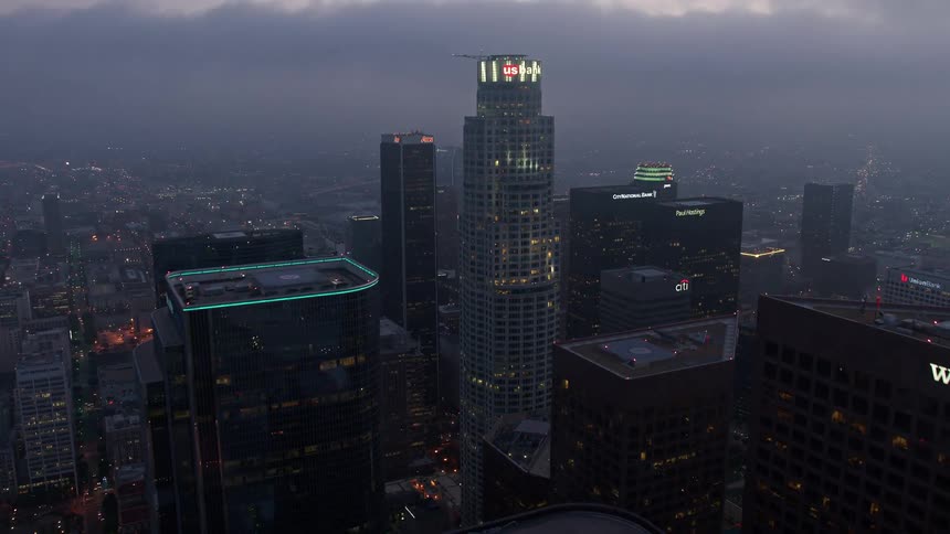 Approaching the towering US Bank Tower in Downtown LA during a cloudy twilight shot in 4K aerial footage