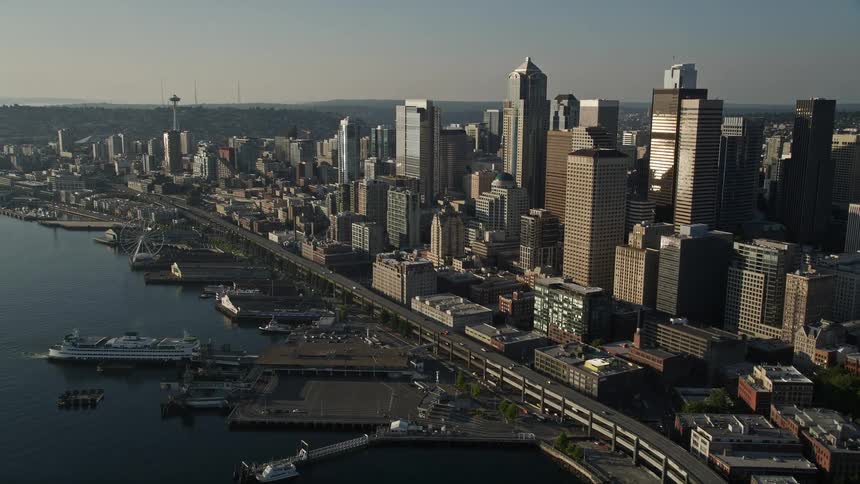 Approaching Seattle's Central Waterfront and Ferry Terminal from an aerial view on a sunny day