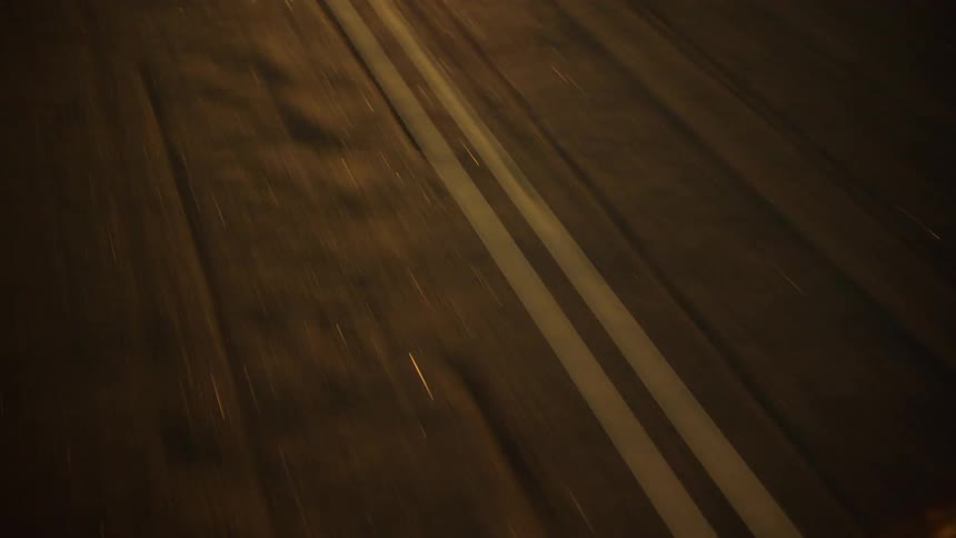 Grooves in asphalt road roughly parallel double lines