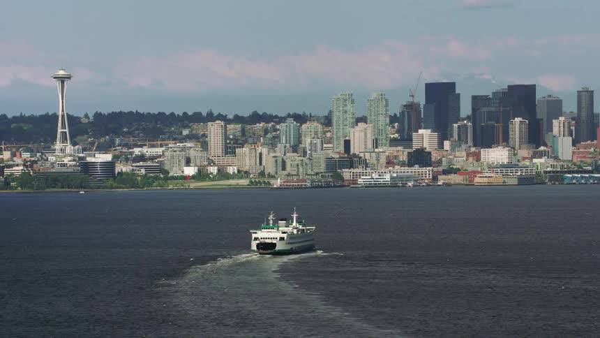 A ship sails along the coast of downtown