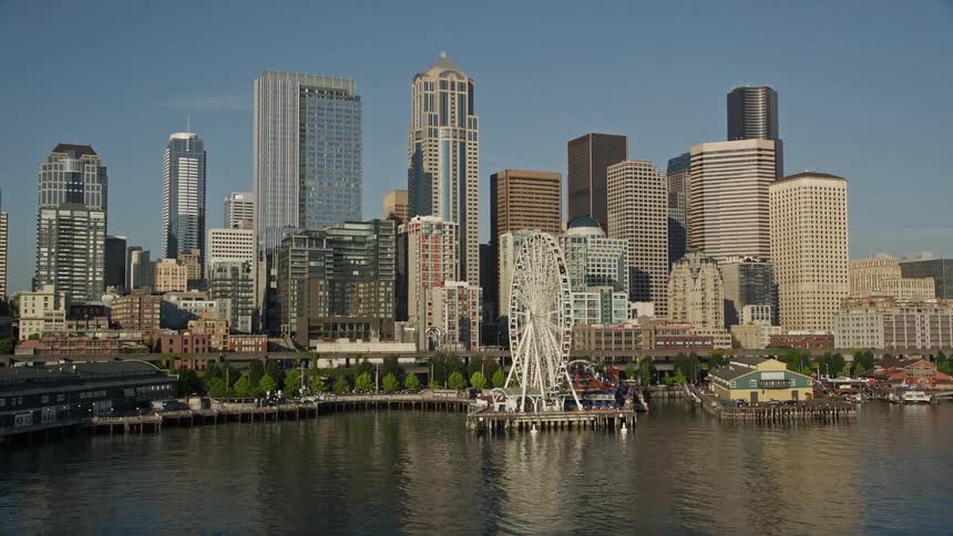  aerial footage showcasing the scenic Seattle Aquarium Great Wheel and Downtown skyline on the Central Waterfront offering a glimpse of the bustling city recreational activities and beautiful harbor views
