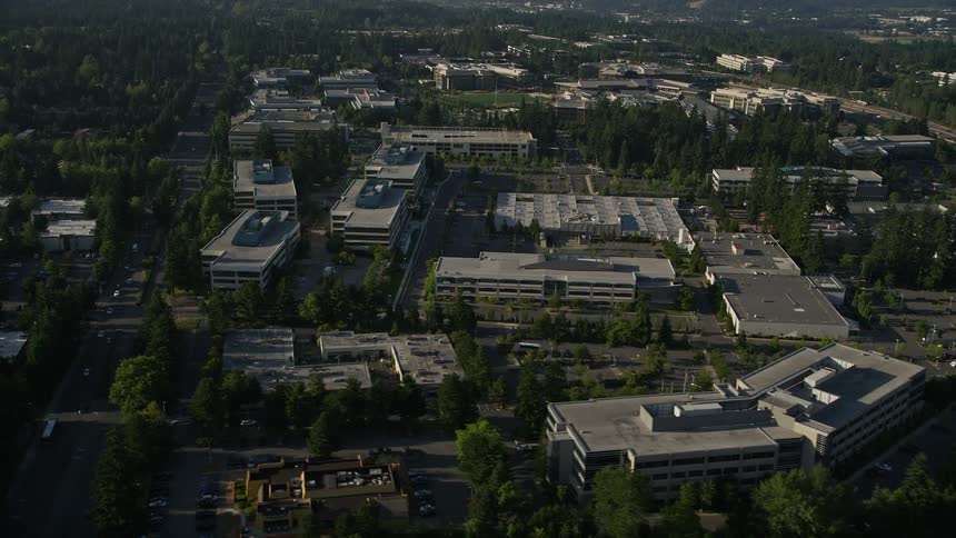 Aerial view of Microsoft Headquarters office complex and nearby freeway with light traffic in Redmond Washington