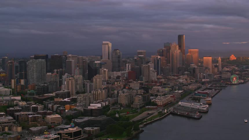 An aerial view of a downtown city area beside a waterfront harbor