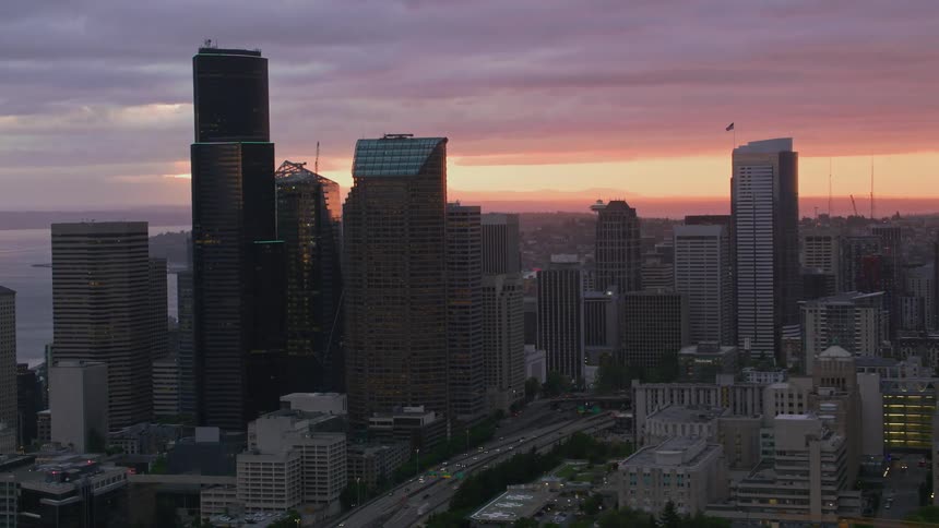 Aerial view of skyscrapers and high rise buildings in downtown area at sunset