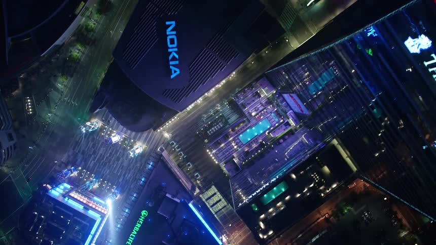 An aerial view of Downtown Los Angeles at night showcasing the citys skyscrapers and bustling streets