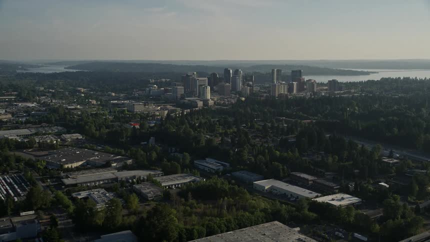 Aerial view approaching Downtown Bellevue Washington with high rise buildings and sunny weather