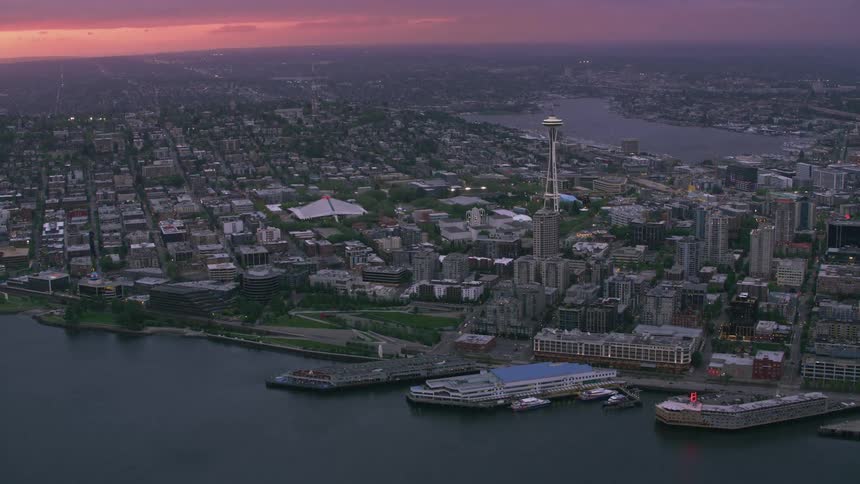 Skyscrapers sit alongside neighborhoods in a coastal city
