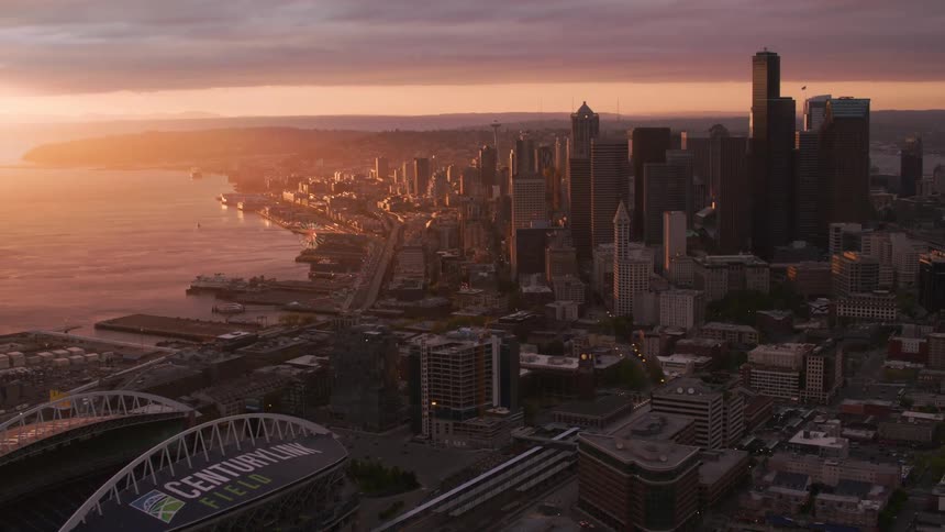 A coastal city center at sunset