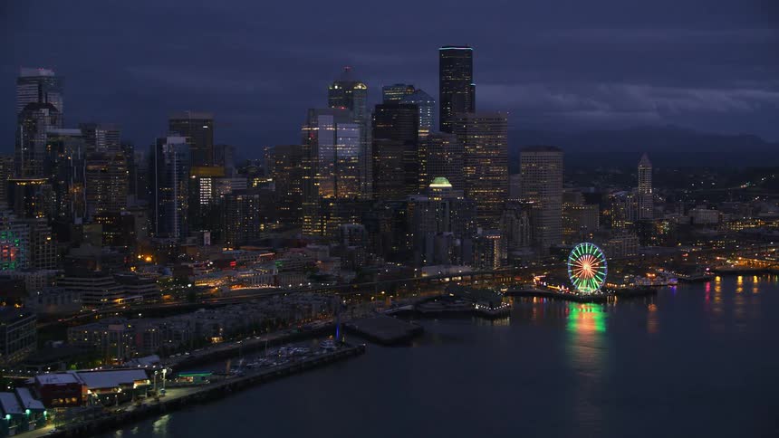 Aerial view of illuminated downtown skyline of the seaport city in the evening