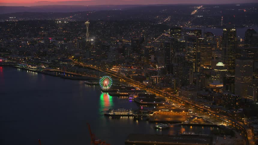 A city along the coast is lit up at night