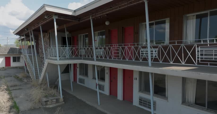 Subtle orbit around the neglected facade of a shutdown vintage motel