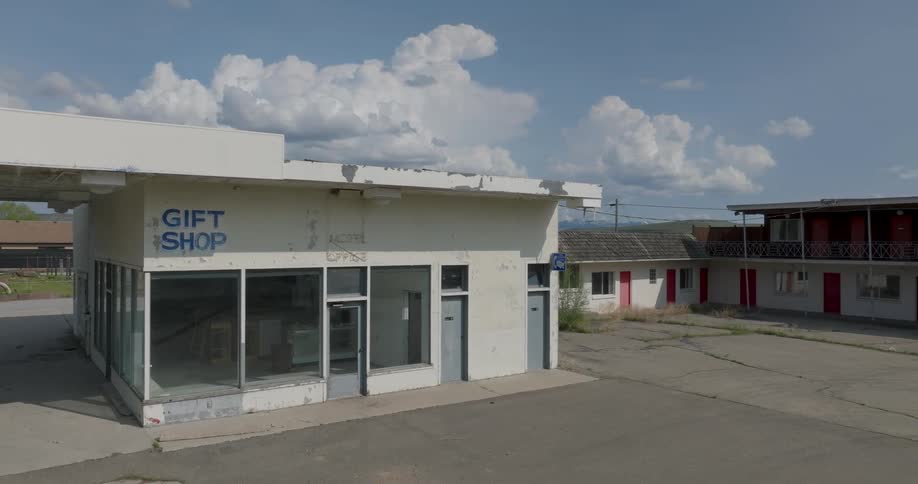 Paint peels away from the old office and gift shop of a seedy seventies motel