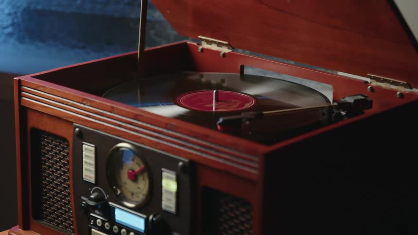 An old record player plays a vinyl record